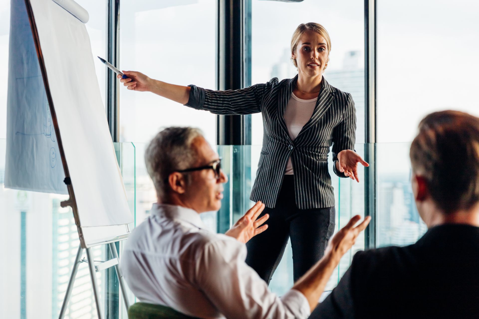 Presenter leading a training session at a flip chart
