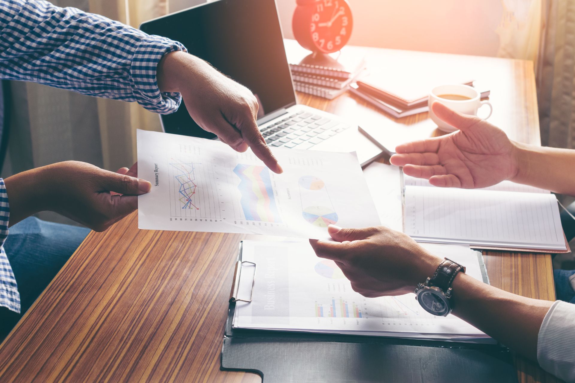 Colleagues reviewing charts and documents together at a desk