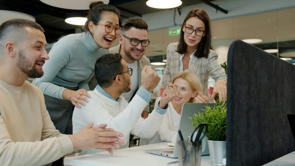 Colleagues smiling and talking together in a modern office